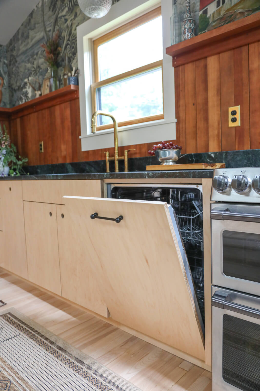 Custom-made plywood kitchen cabinets in Northampton, Massachusetts. An integrated dishwasher is shown open.