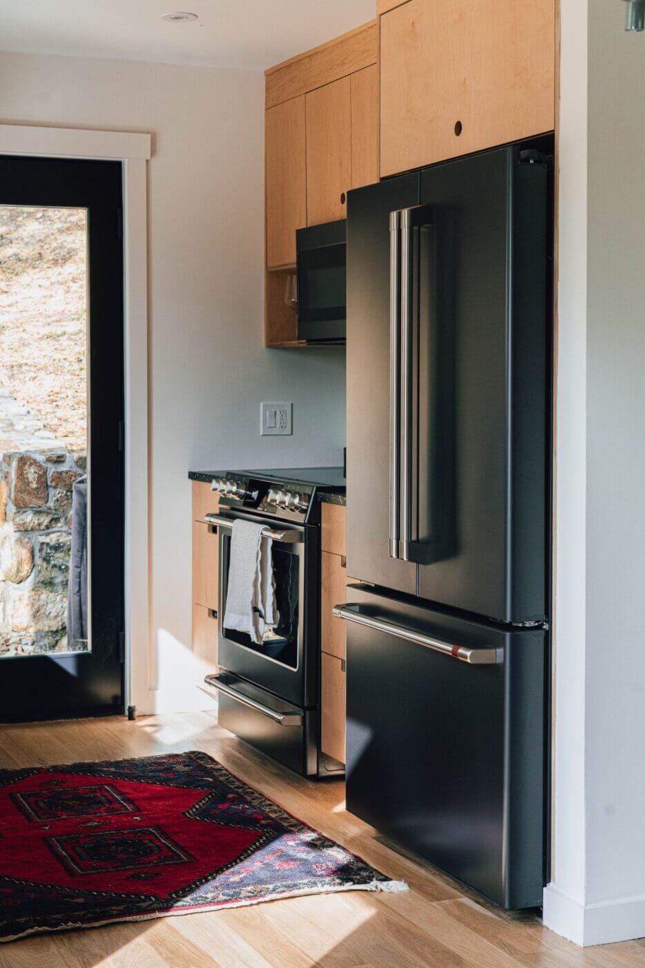 fridge and stove in modern plywood kitchen