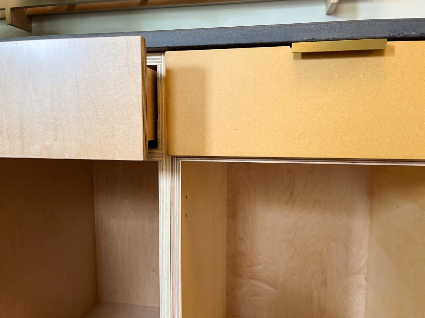 Cabinets are made without edge banding, and designed to show off the beautiful edges of our high-quality plywood cases and fronts. The cabinet on the left shows a clear-coated maple veneer finish, while the cabinet on the right is our Turmeric custom color finish over Medex.